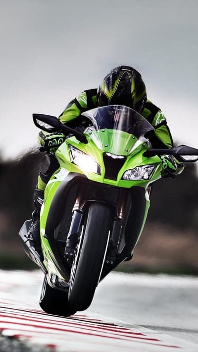 Rider on Green Sportbike Leans into Corner on Track