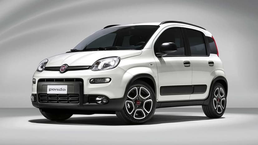 White Fiat Panda city car in a studio with soft lighting, black trim, and unique alloy wheels on a gray background.