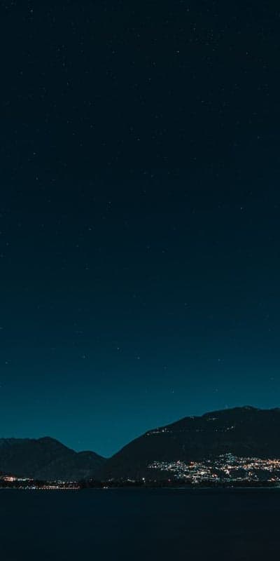 Town Glow Under a Starry Veil - Lakeside Night Panorama