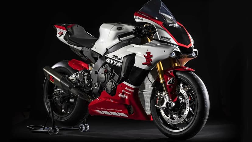Yamaha YZF-R1 20th Anniversary motorcycle with white and red livery, carbon fiber exhaust, and gold forks.