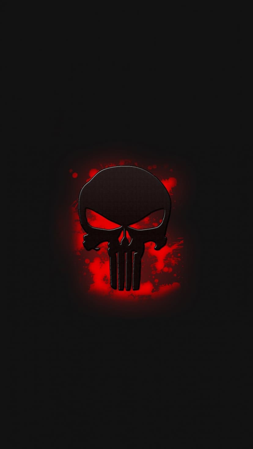 Punisher skull emblem in weathered dark metal glows against a backdrop of vibrant red paint splatters.