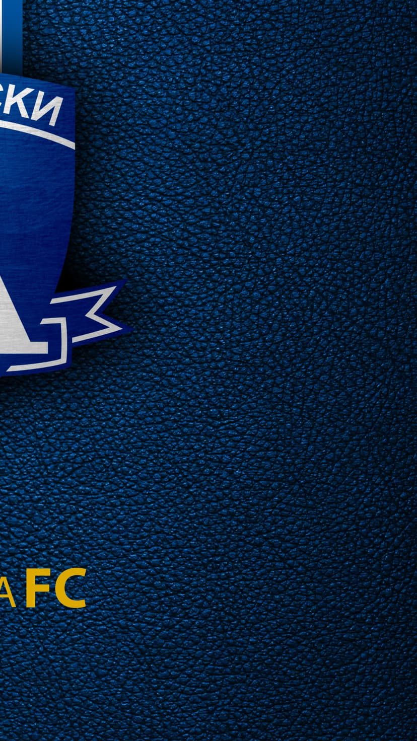 Navy blue textured leather surface with a partial white and blue shield logo featuring yellow FC lettering.