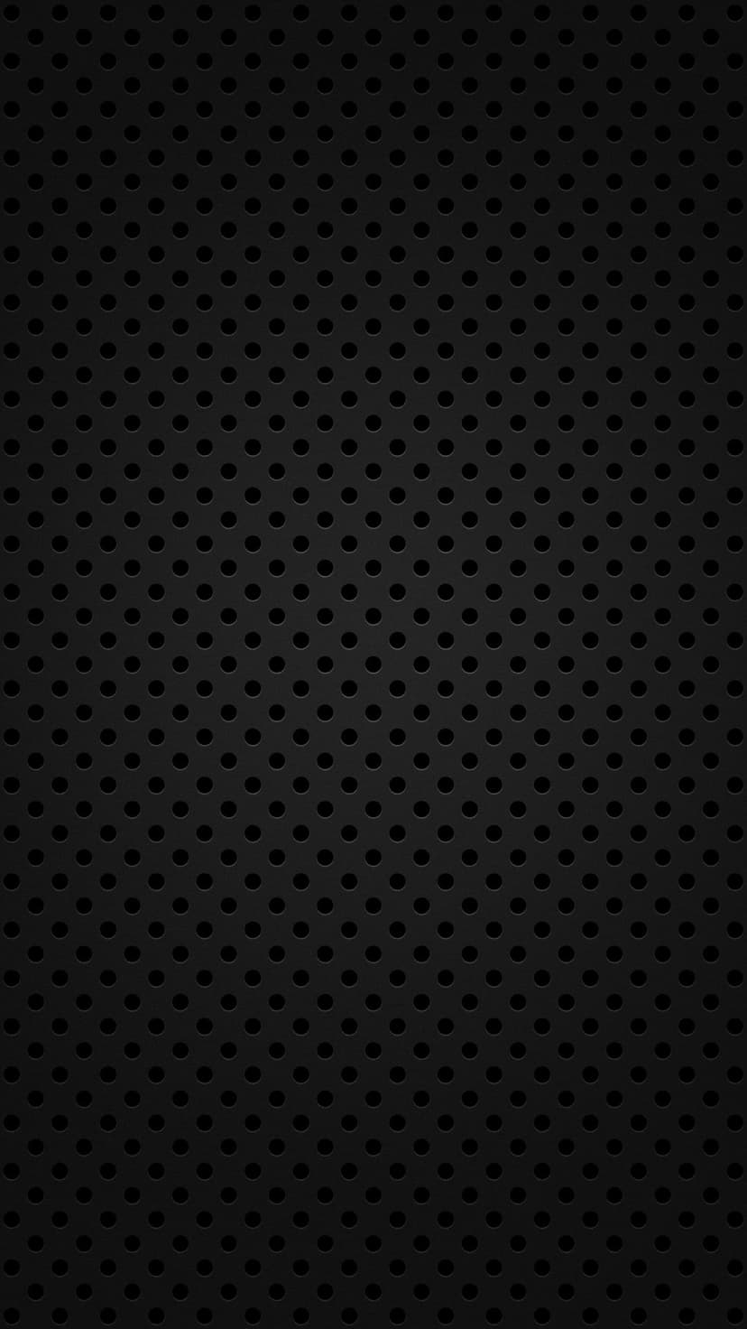 Matte black steel surface featuring a uniform pattern of small circular holes for an industrial look.