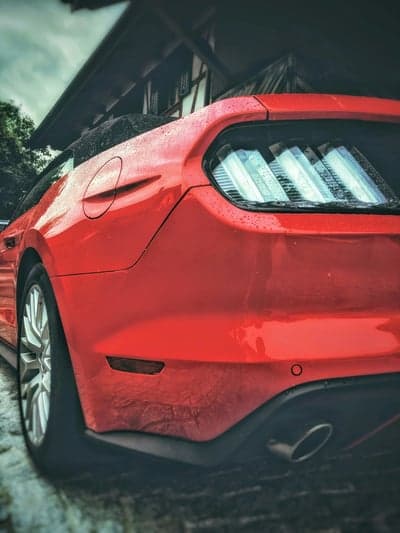 Vibrant Red Mustang Rear Rain Drops Mobile Wallpaper