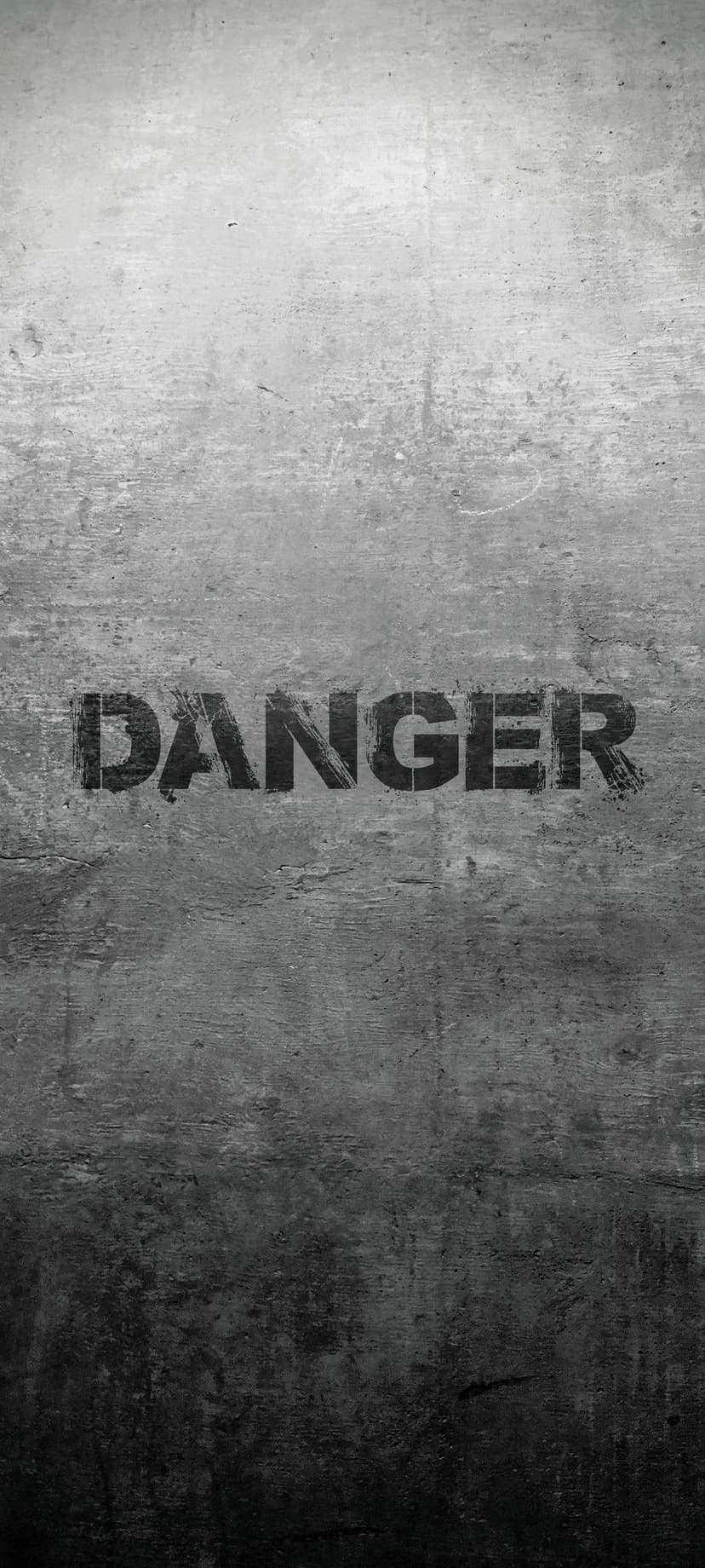 Danger sign stenciled on a scratched grey concrete wall with visible cracks and heavy industrial texture.