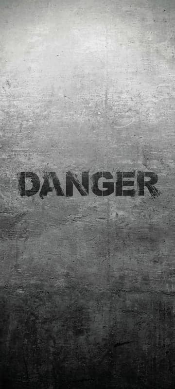 Danger Sign on Grungy Concrete Wall Background