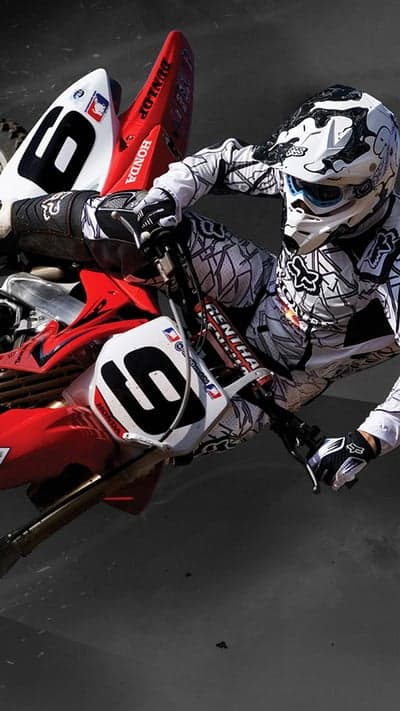 Motocross Rider in Mid-Air on Red and White Honda