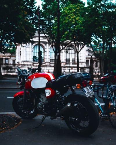 Red Ducati Motorcycle Parked Outside Parisian Building