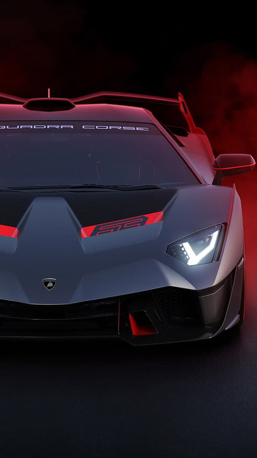 Lamborghini SCV12 front view with glowing red LED headlights, carbon fiber aero, and dark grey metallic paint.