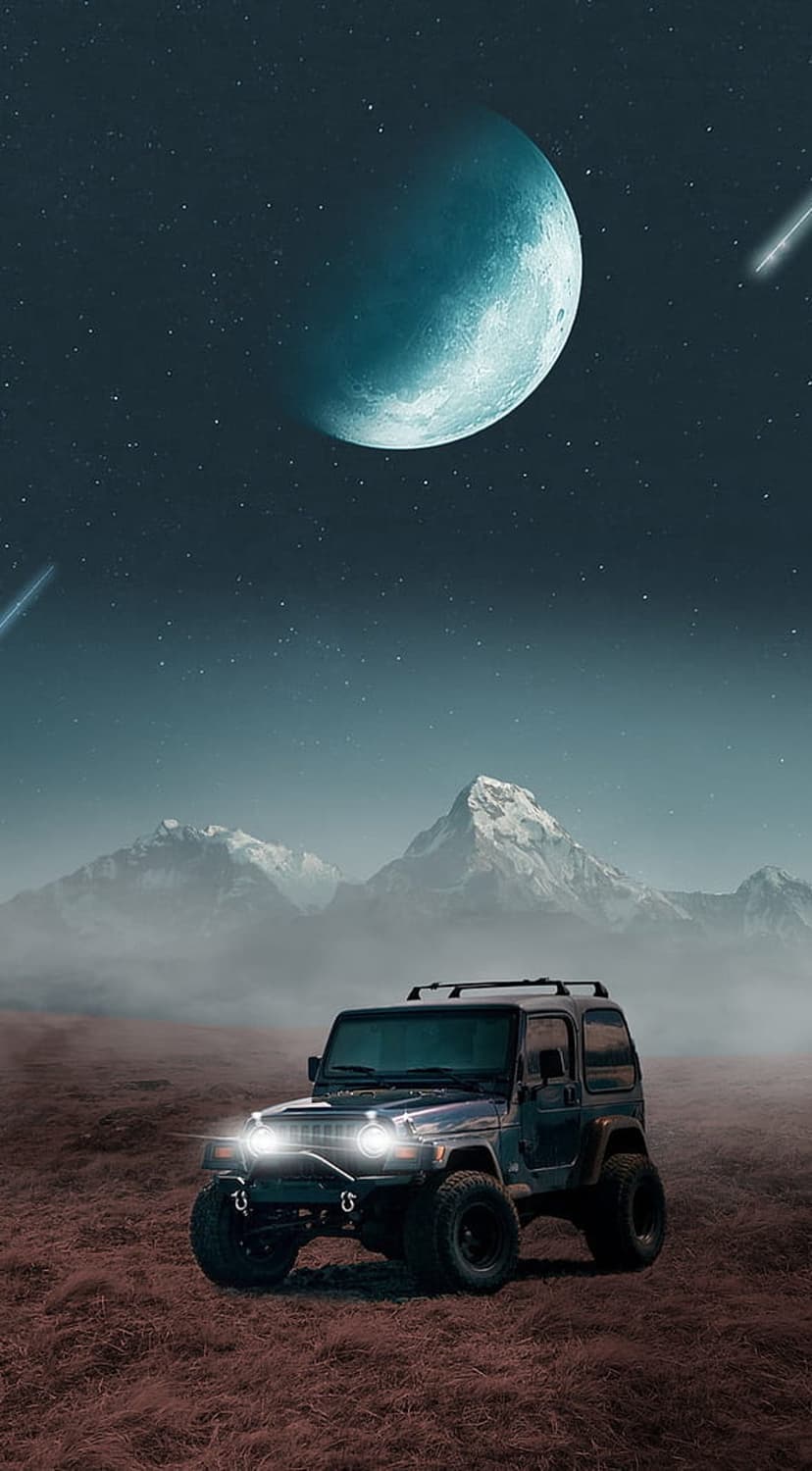 Jeep Wrangler with glowing headlights sits on reddish terrain under a giant aquamarine moon and shooting stars.