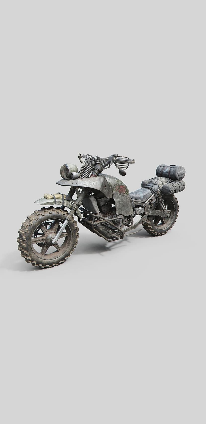 Weathered motorcycle with oversized off-road tires and gear-laden luggage racks in a dusty wasteland setting.