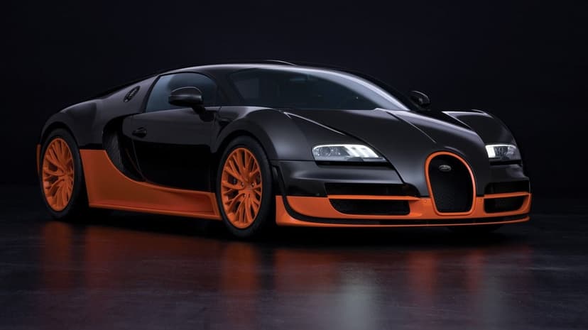 Black carbon fiber Bugatti Veyron Super Sport with orange accents and wheels on a reflective dark studio floor.