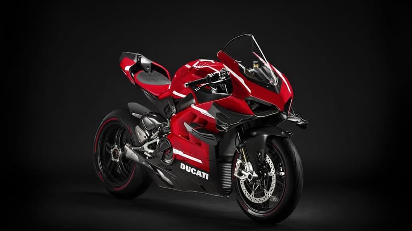 Red Ducati Superleggera V4 sportbike with carbon fiber winglets on a solid black studio background.