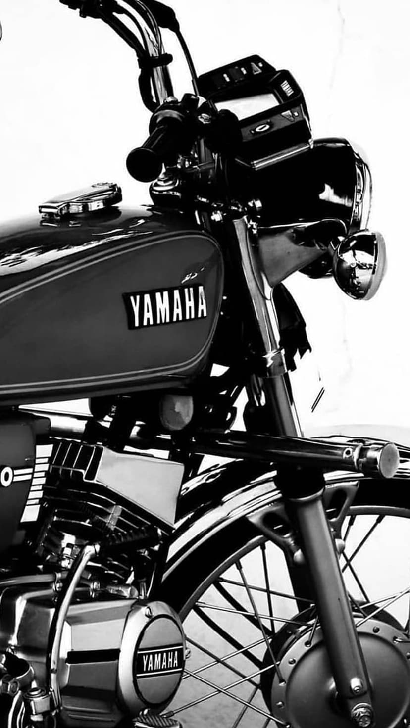 Yamaha motorcycle engine and chrome pipes in a black and white close-up shot for a vertical mobile wallpaper.