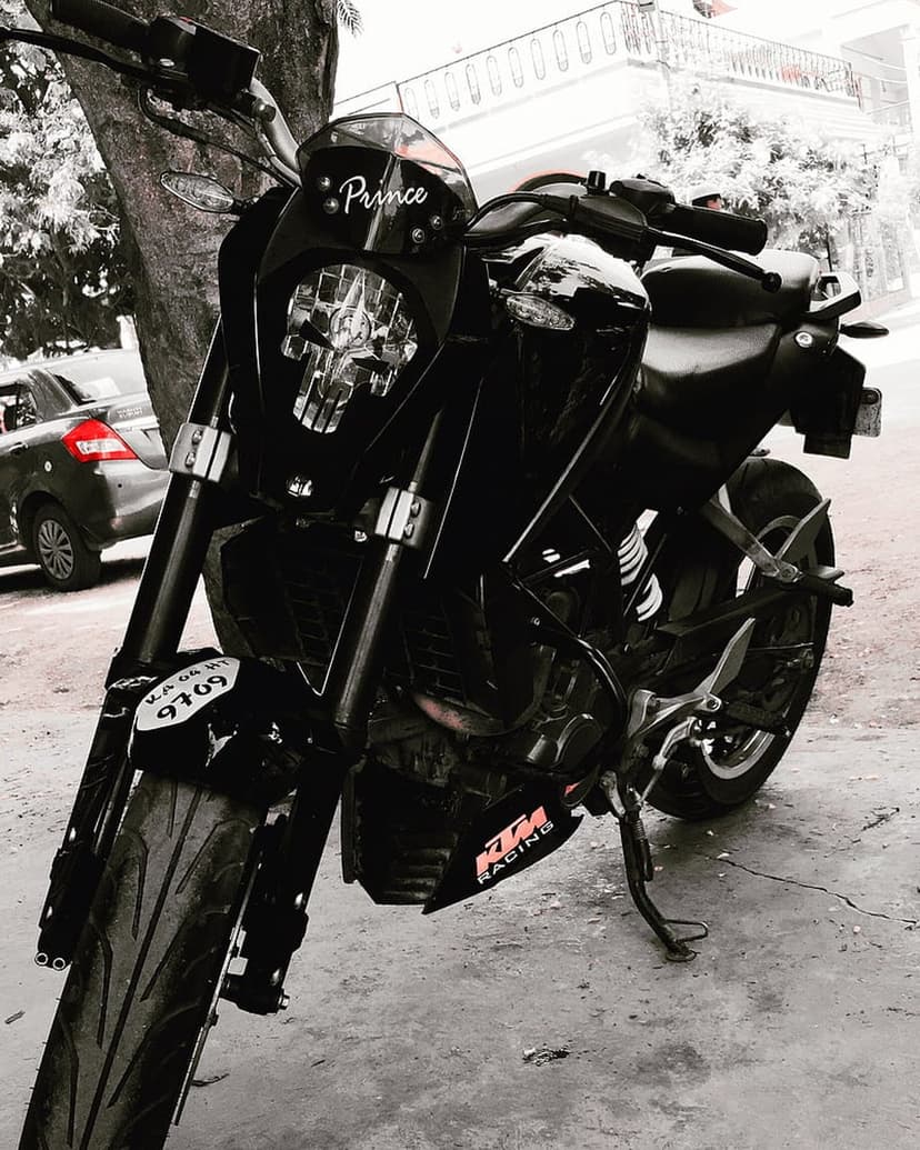 KTM Duke motorcycle in black and white featuring a Prince decal and number plate on the front headlight assembly.