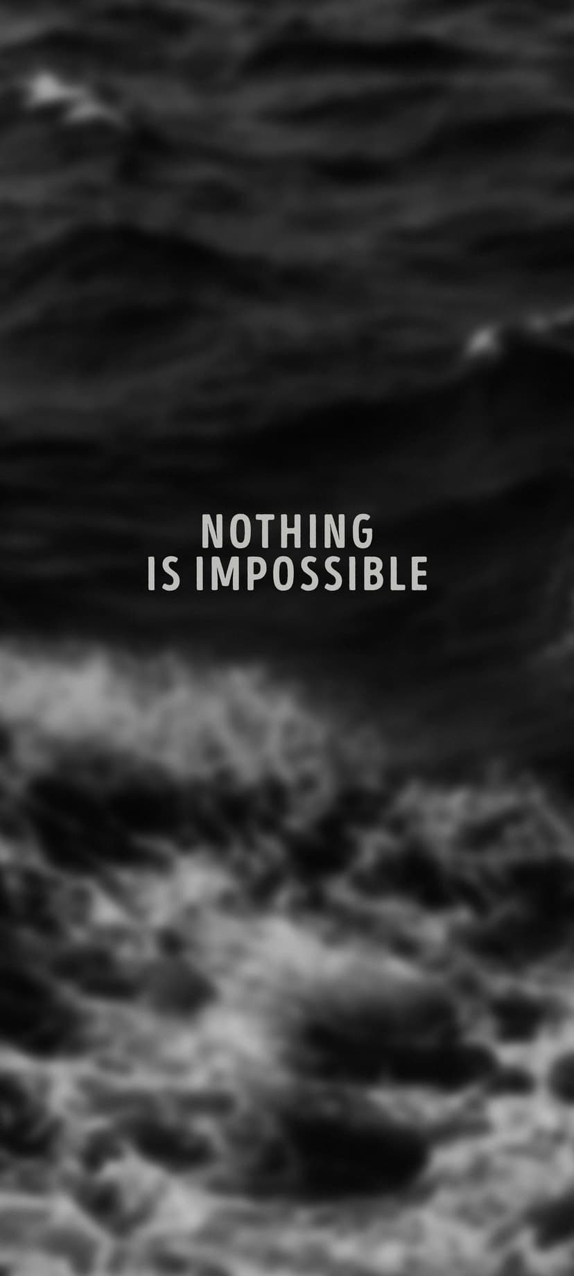 Nothing is Impossible quote in white text centered over dark, high-contrast ocean waves in black and white.