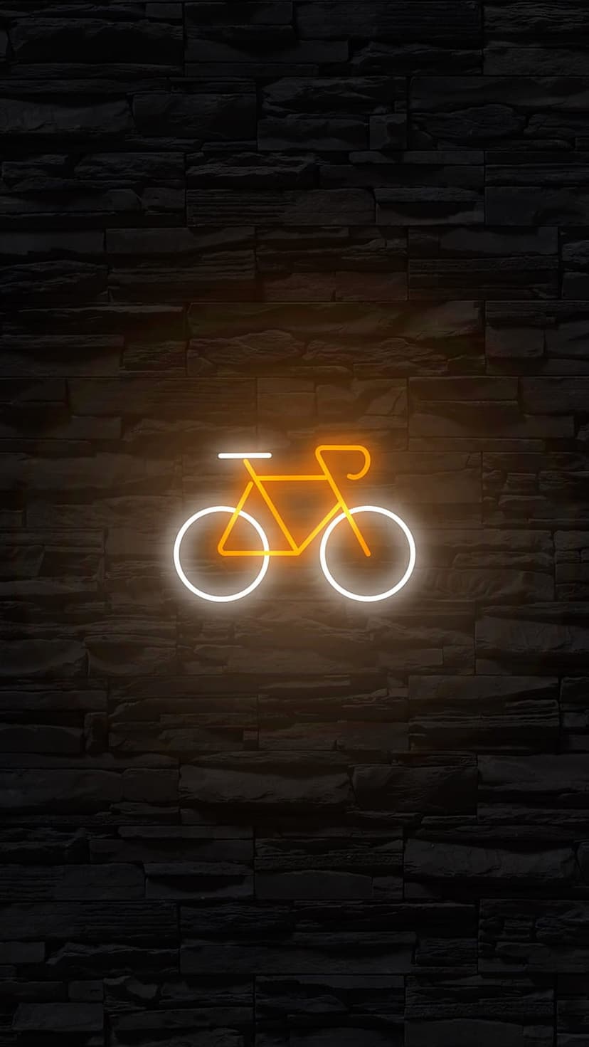 Neon bicycle sign with an orange frame and white wheels glowing against a dark, textured grey stone wall.