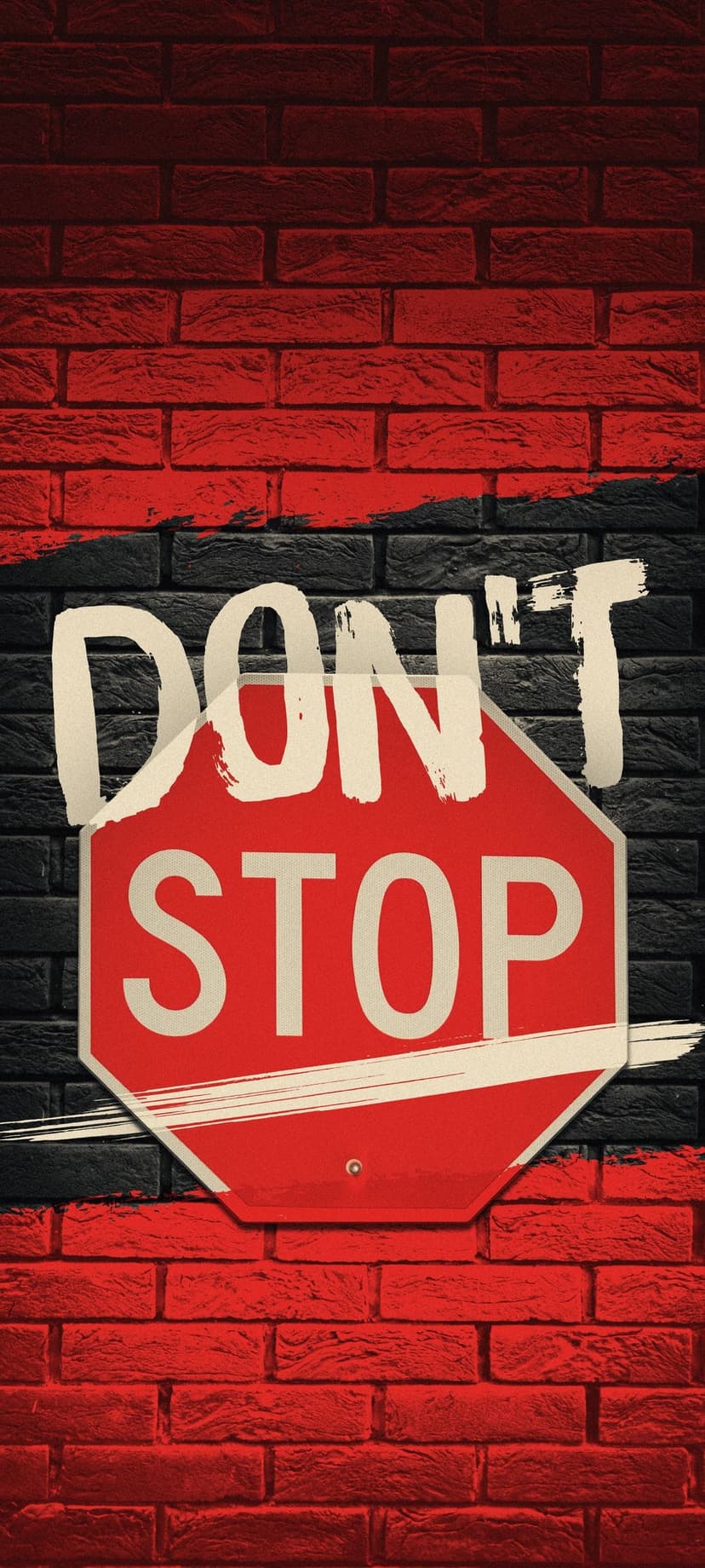 Red octagonal stop sign with distressed white Don't Stop text mounted on a dark textured brick wall background.