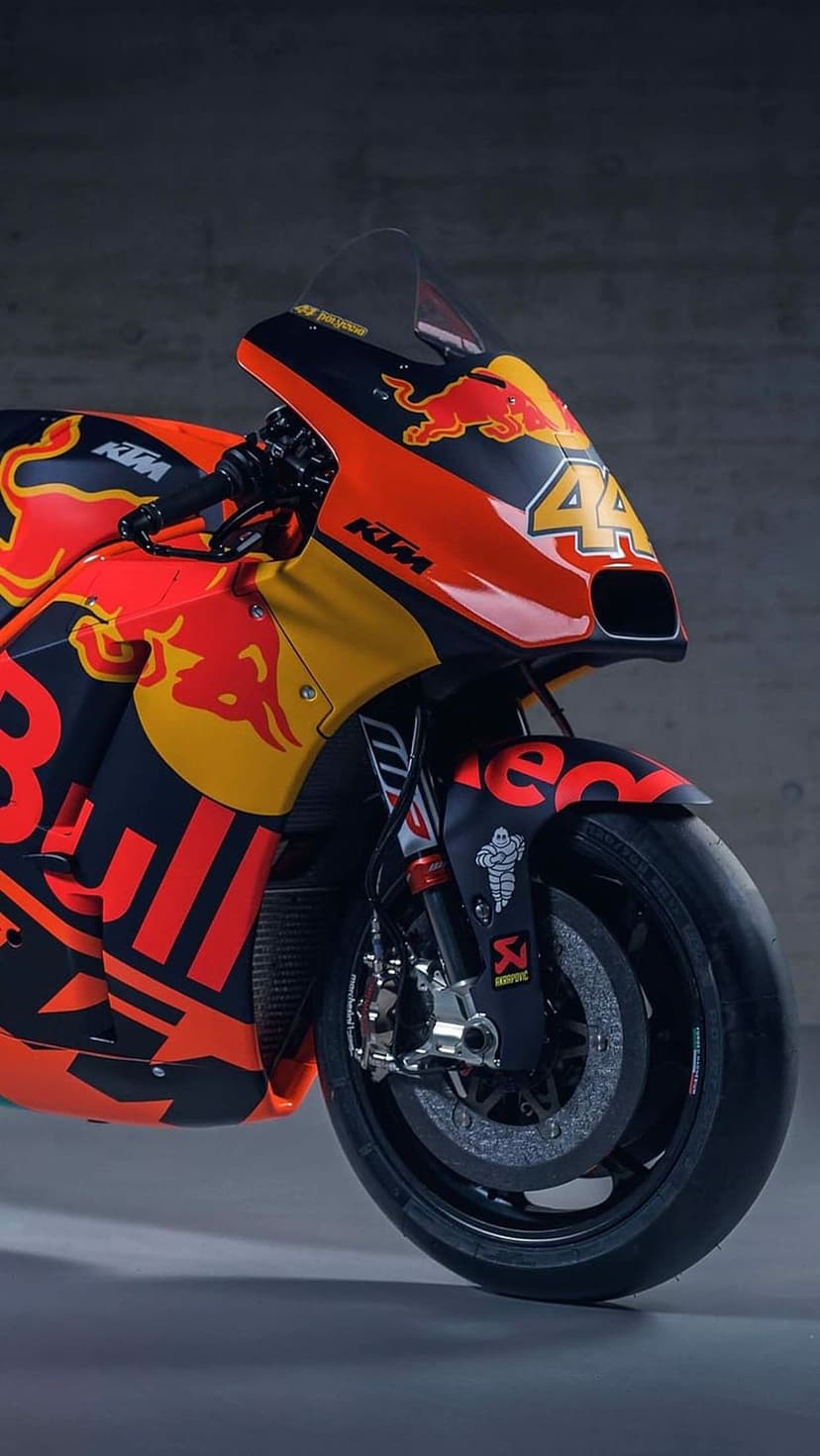KTM Red Bull racing bike with number 44 showcases front wheel brakes and suspension against a black background.
