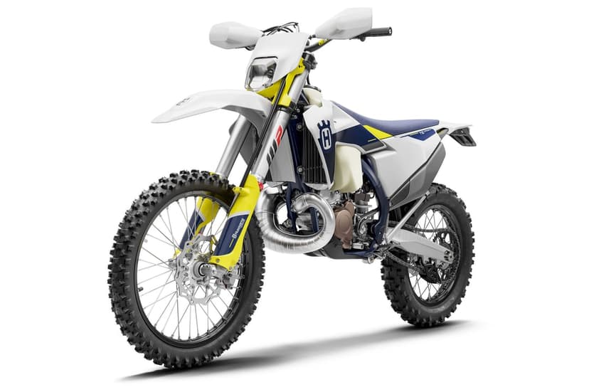 Husqvarna TE 250 enduro dirt bike with white fairings and knobby tires isolated on a plain white background.