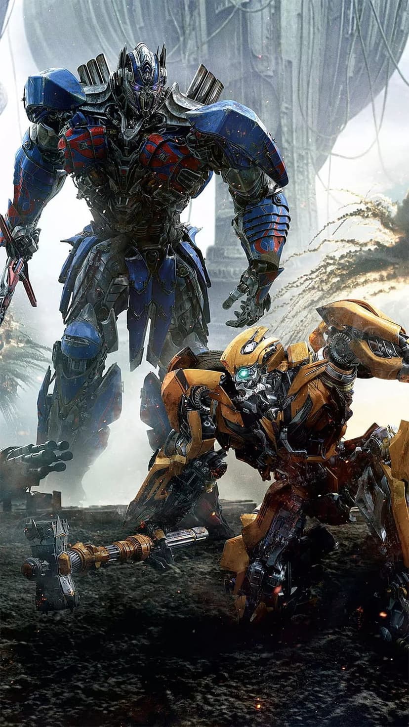 Optimus Prime and Bumblebee stand together in a hazy, smoke-filled battlefield with glowing blue optics visible.