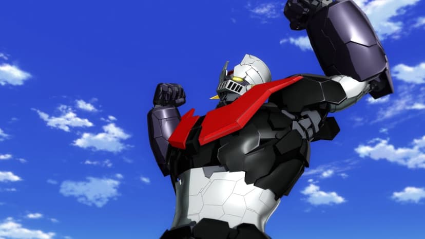 Mazinger Z mecha with raised fists and red chest armor stands against a bright blue sky with white clouds.