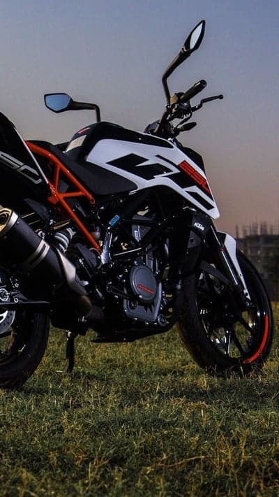 KTM Motorcycle on Grass at Sunset