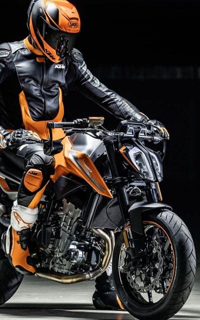 Rider in orange and black KTM gear on motorcycle