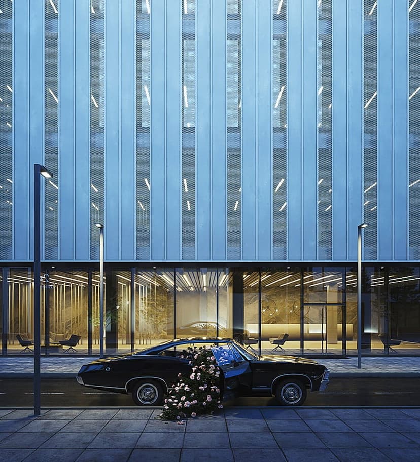 Black vintage car with open door overflowing with white and pink roses parked by a blue glass building.