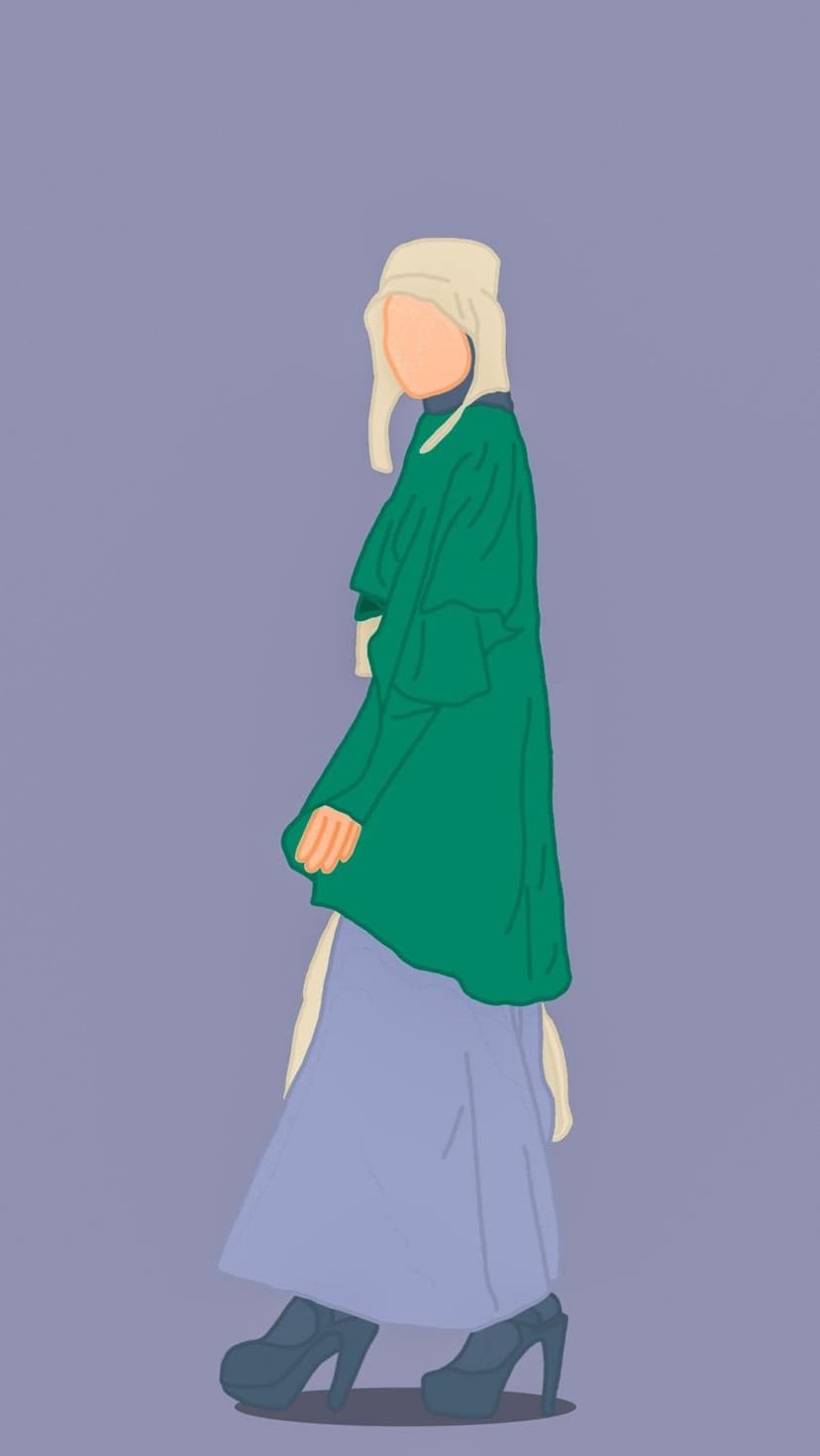 Woman in a green coat and cream headscarf stands against a solid lavender background in high-heeled shoes.