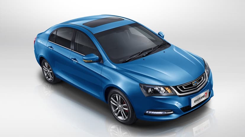 Metallic blue Geely Emgrand 7 sedan on a clean white studio background with soft floor reflections and detail.
