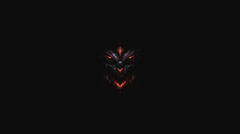 Demonic face with glowing red eyes and a fiery mouth emerging from deep shadows on a black background.