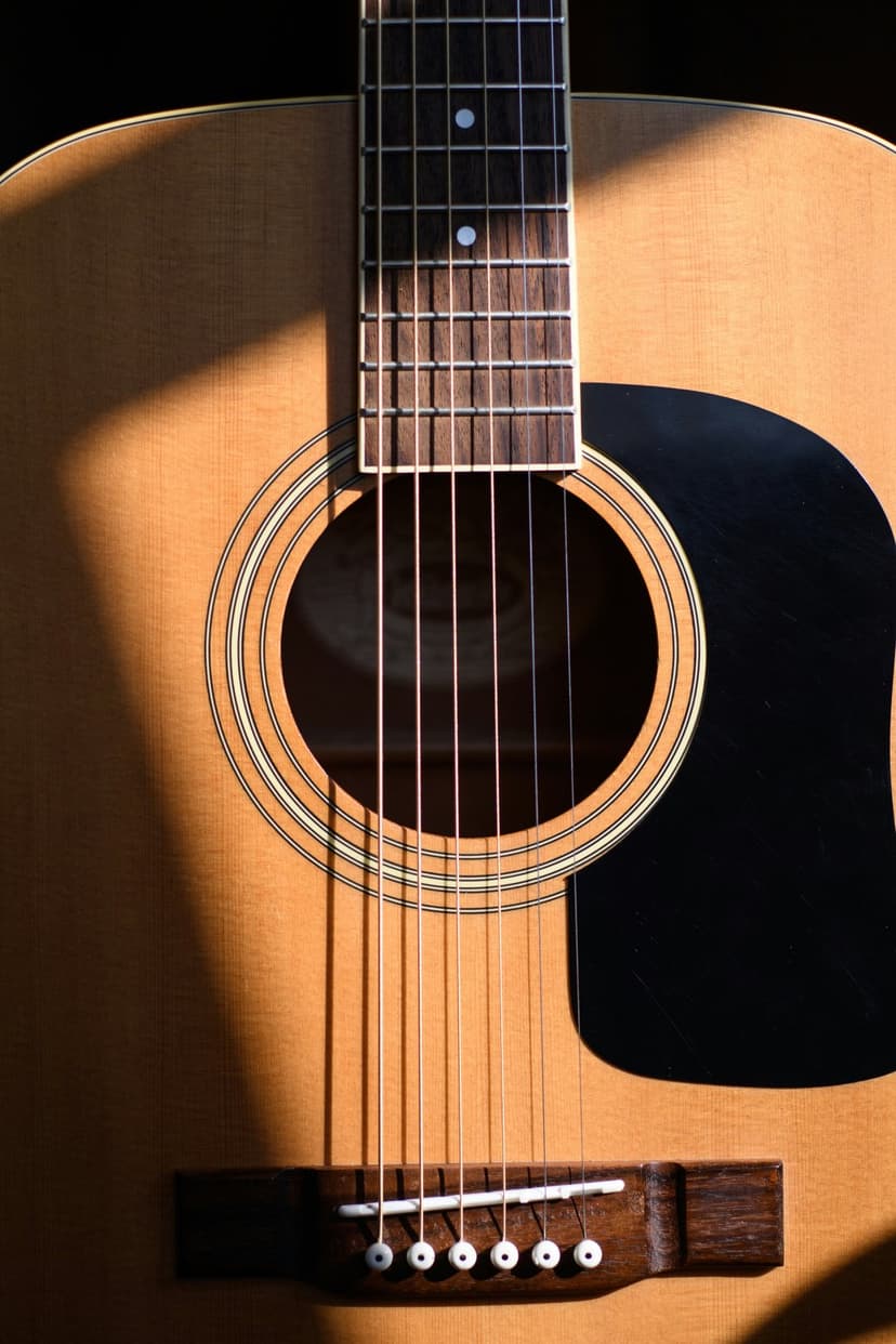 Acoustic guitar strings and soundhole illuminated by sunlight, highlighting wood grain and deep shadows.