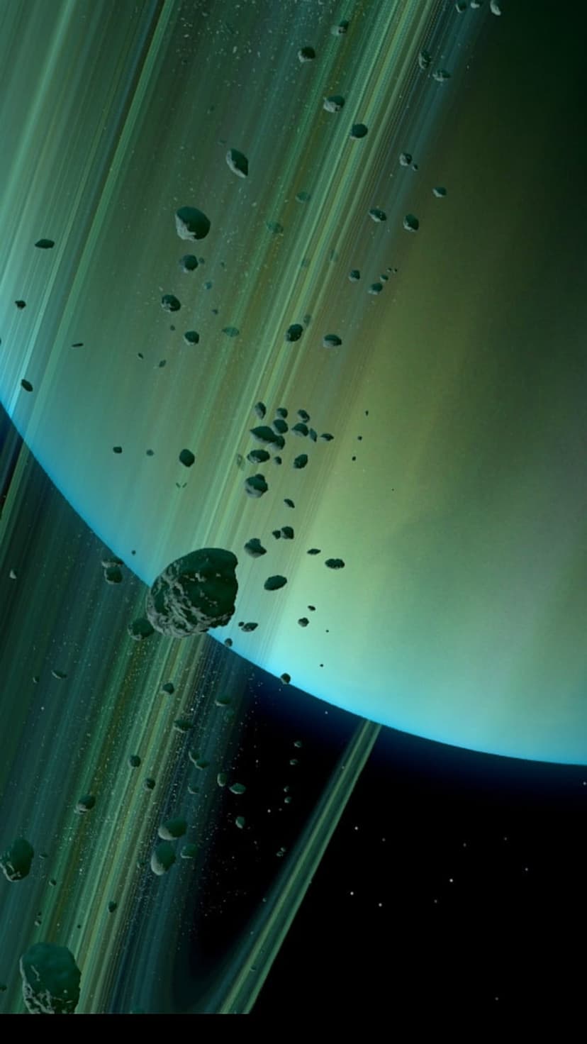 Jagged asteroids float before a giant planet surrounded by glowing green rings in a dark star-filled space.