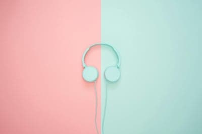 Minimalist Headphones on Pink and Teal Background