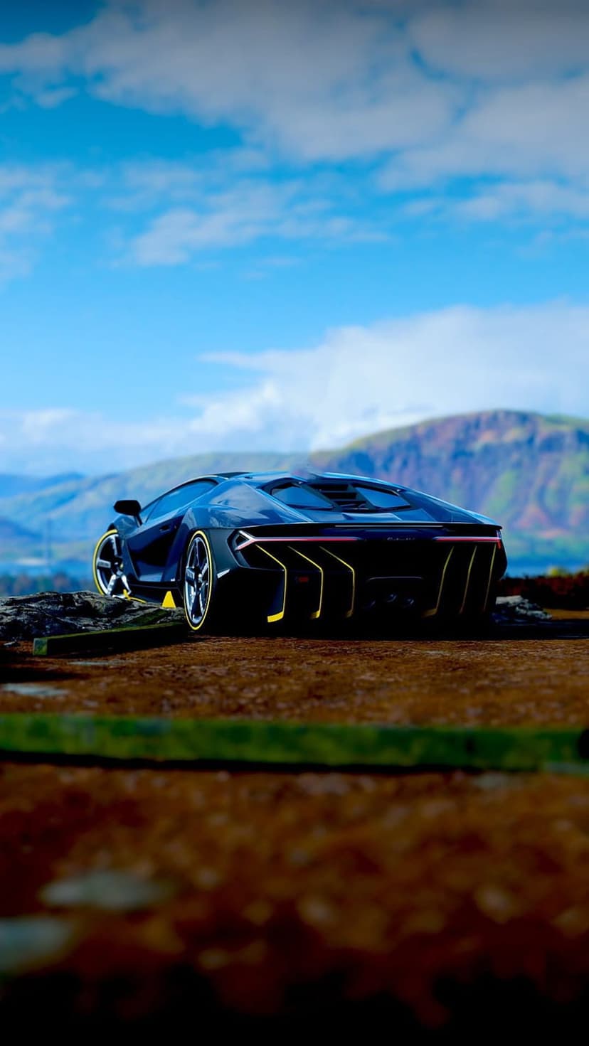 Black Lamborghini Centenario rear view showing yellow accents and carbon fiber on a mountain dirt road.