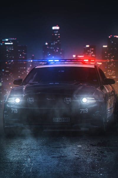 Nighttime Police Car in City with Blue and Red Lights