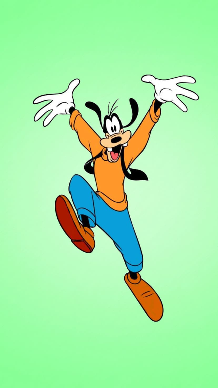 Goofy jumps with arms raised high wearing an orange shirt and blue pants against a solid green background.
