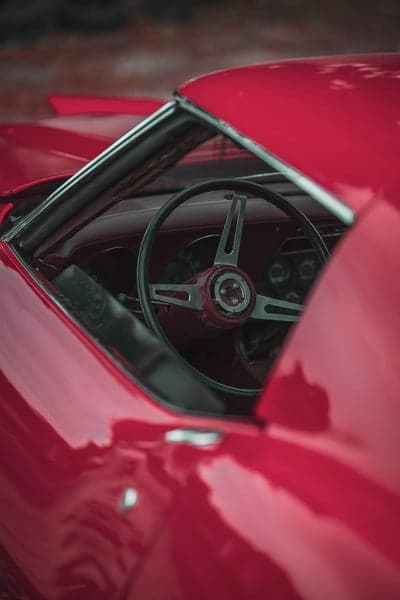 Classic red car interior steering wheel detail