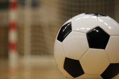Close-up of a classic black and white soccer ball indoors