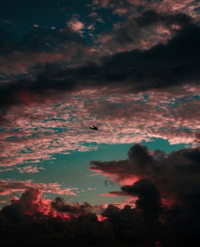 Helicopter flying through dramatic sunset clouds