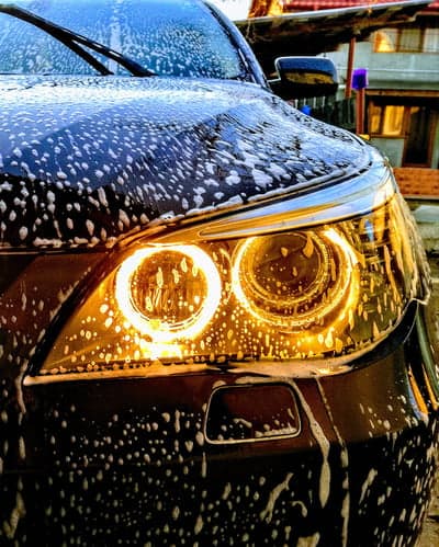 Car wash with soap bubbles on headlights