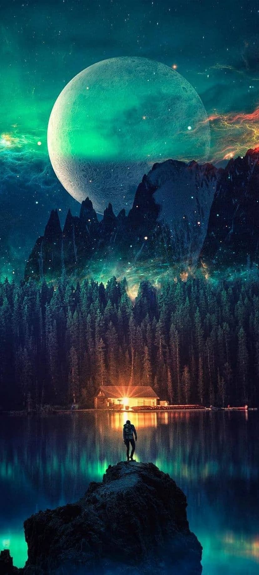 Man standing on a jagged rock overlooking a glowing cabin and a mountain lake under a green aurora borealis sky.