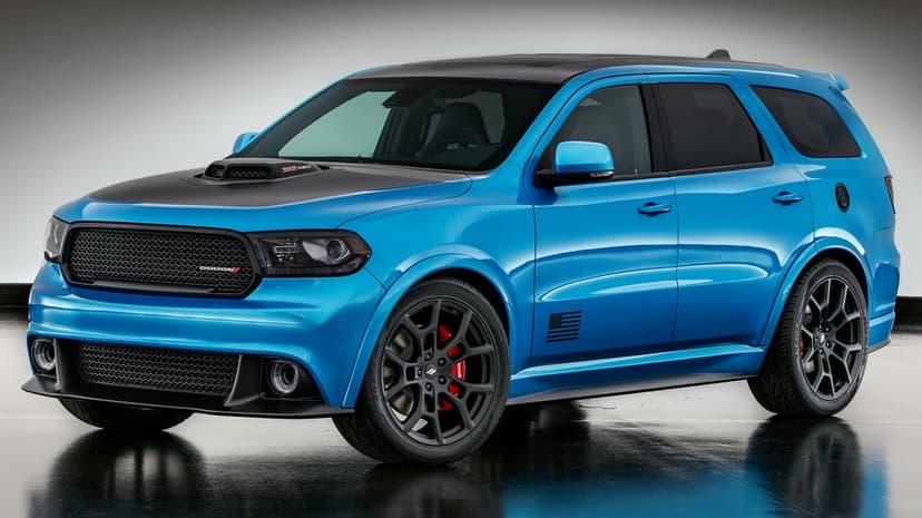 Blue Dodge Durango SRT SUV with black hood and red brake calipers on a reflective studio floor.
