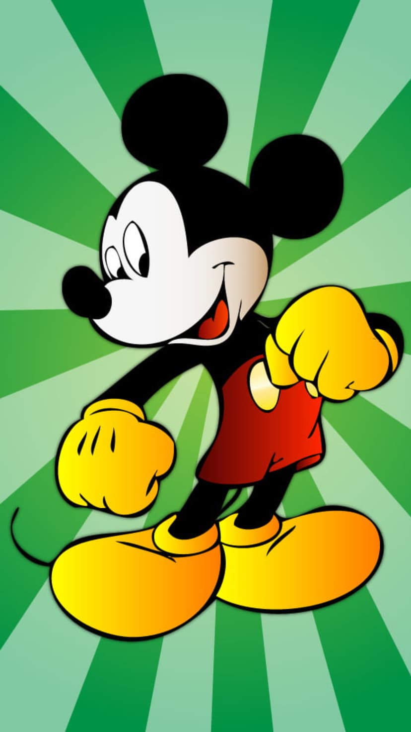 Mickey Mouse in red shorts and yellow shoes poses confidently before a radiating green burst background.