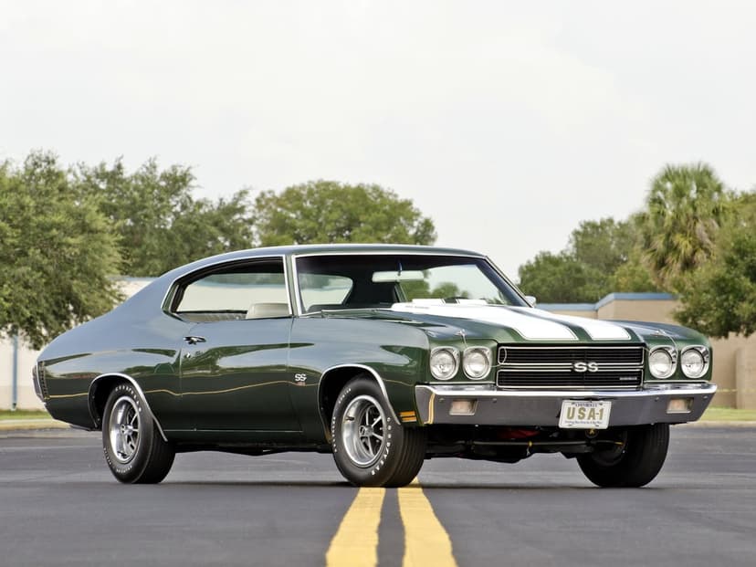 Forest green 1970 Chevrolet Chevelle SS with white stripes on an asphalt road with yellow lines.