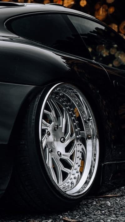 Close-up of shiny chrome wheel on black car