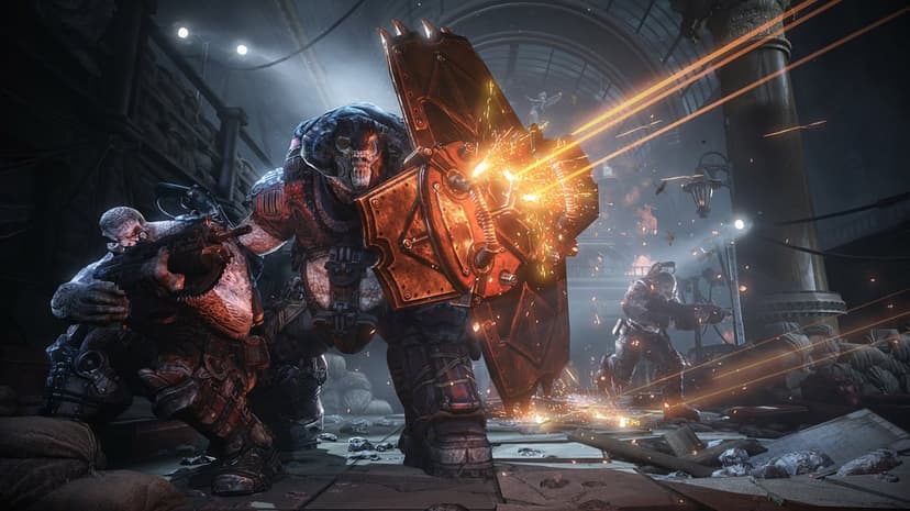 Armored soldier deflects glowing orange tracers with a massive shield during intense combat in a dark hall.