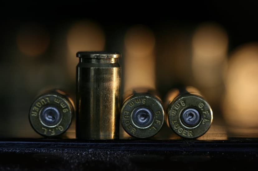 9mm Luger brass casings with G.F.L. markings feature a polished metallic sheen in a shallow depth of field shot.