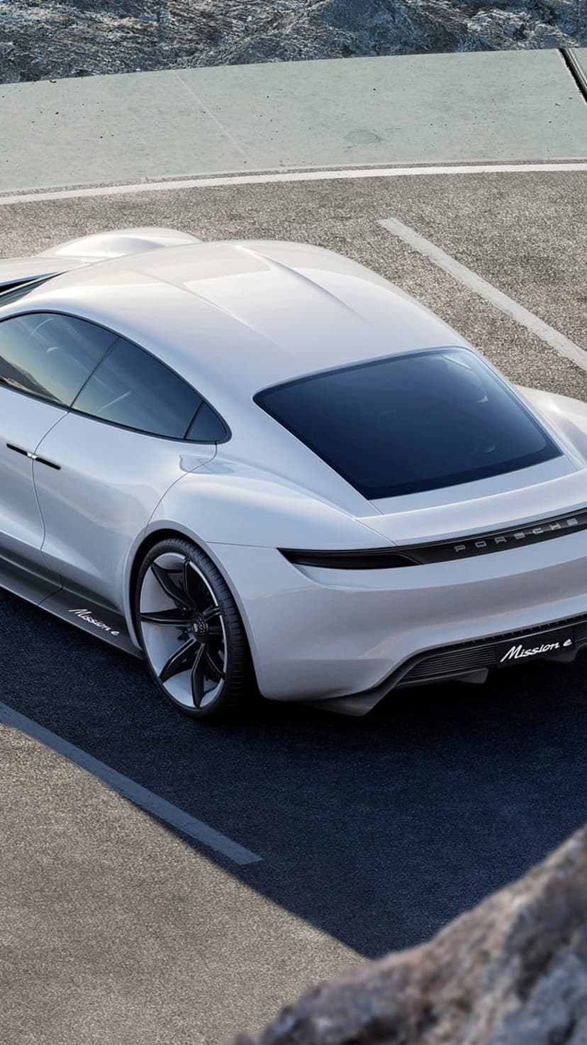White Porsche Mission E concept car rear view featuring a full-width LED taillight and dark aerodynamic diffuser.